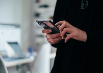 Kvinna håller i mobiltelefon